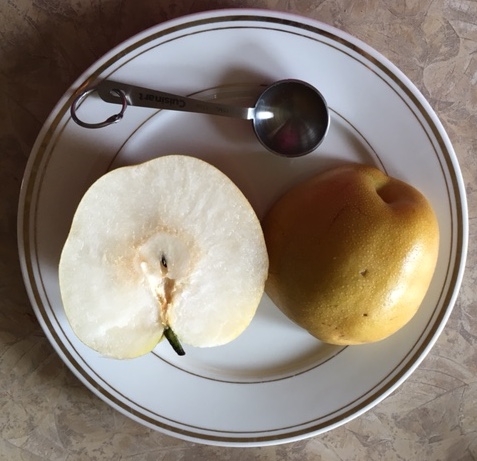 An asian pear is juicy and tasty. It is a healtlhy treat.