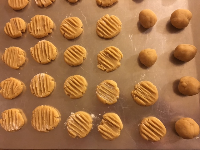 Cookies are flattened with a fork and baked.