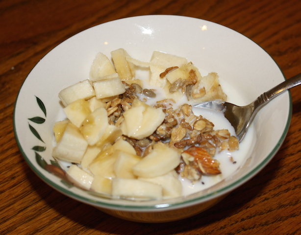 A tasty bowl of crunchy granola with diced bananas