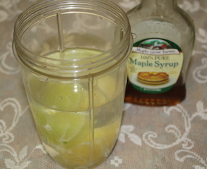 lemon and lime slices in blender container waiting to be blended