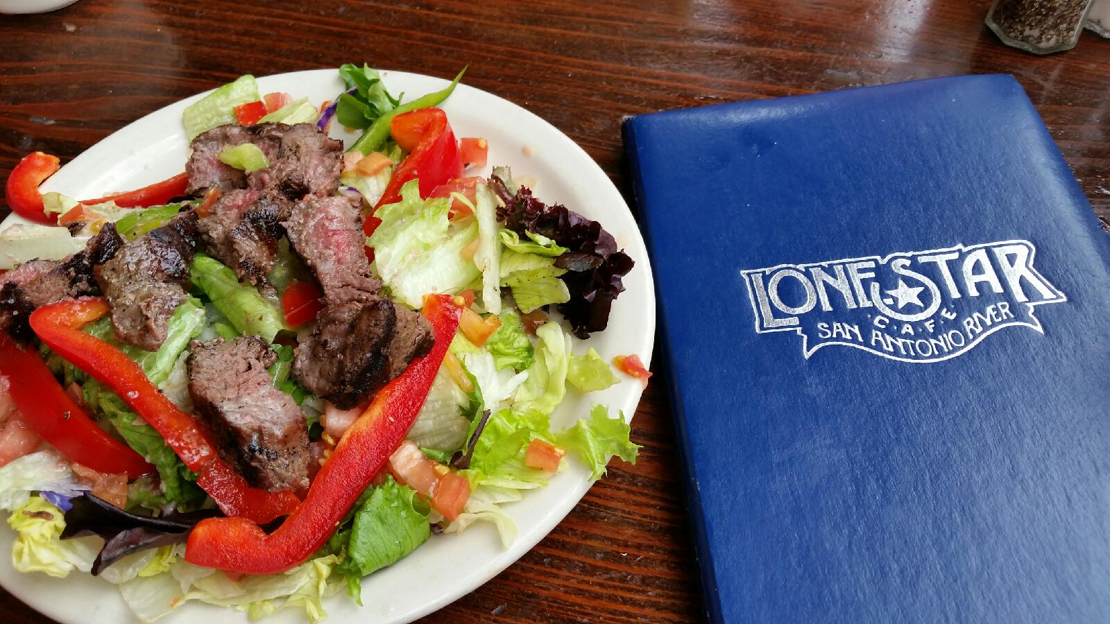 a tasty steak strip salad with red peppers and crispy greens.
