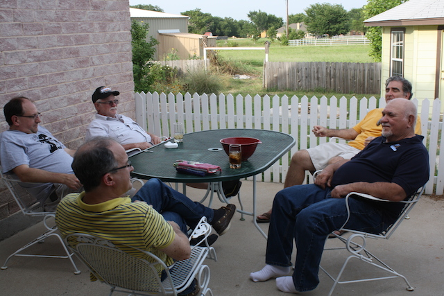 Men relaxing on the patio.