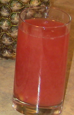 A tall glass of rosy raspberry mango water