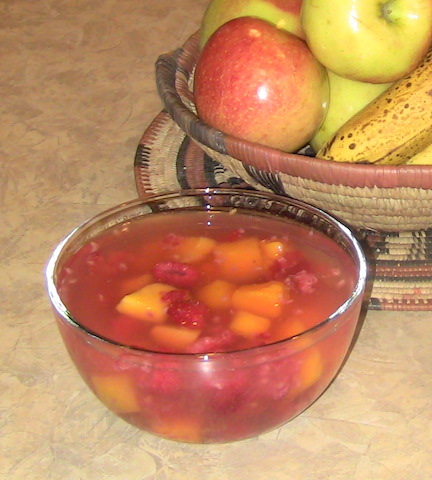 mangoes and strawberries in a bowl of water, infusing their flavor into the water-so colorful