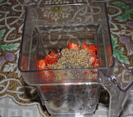 blelnder container full of fruit and chia and flax seeds. makes a yummy smoothie