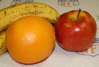 speckled banana, an orange and an apple - a healthy treat to start the day