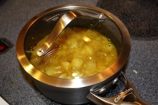 apples and spices simmer on the stovetop