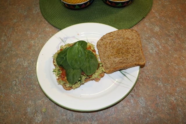 Spinach on top of the salsa makes a colorful sandwich. Kale could be used or lettuce even