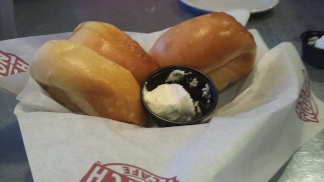 a lovely basket of warm fragrant rolls with a small container of butter