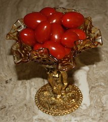 A candy dish full of grape tomatoes