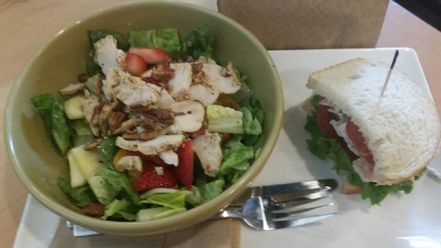A strawbery poppy seed and chicken salad with plenty of crispy greens and pecans.