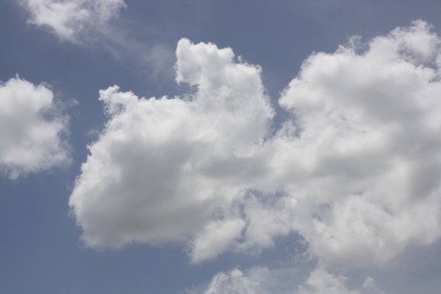 fluffy clouds floating in a blue sky are so relaxing.