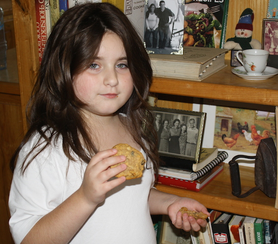 Ella eating a freshly baked oatmeal cookie.