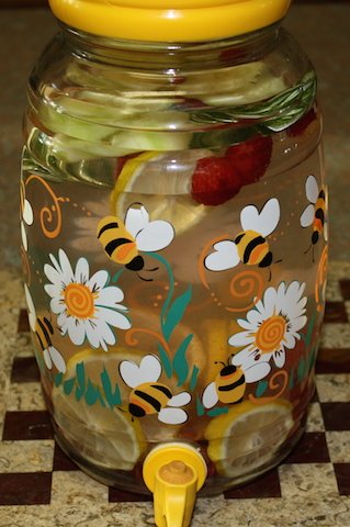 A brightly decorated springtime jar full of refreshing fruit water