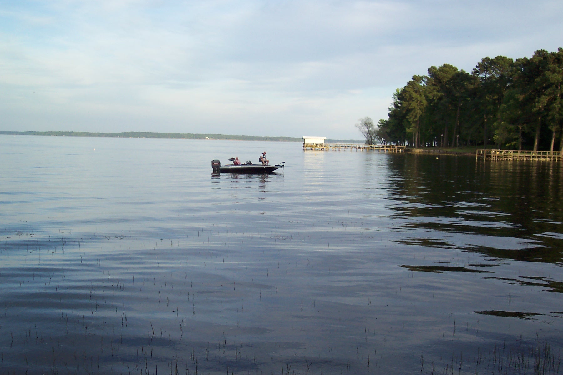 Fisherman drifting with the tide, relaxing as they cast their lines into the water