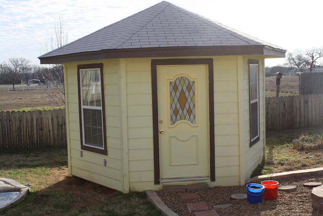 a colorful yellow "gazebo house" can protect growing plants form cold weather