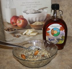 A bowl of chia oatmeal with almonds and maple syrup