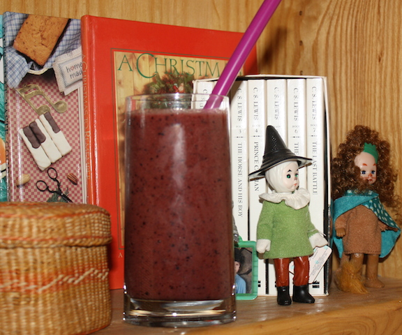 A nice pear smoothie on a bookshelf