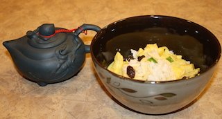 A decorative bowl filled with rice and curried chicken full of health giving ingredients