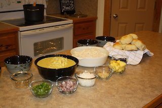 curry, rice, toppings and homemade dinner rolls arranged on the counter for dinner