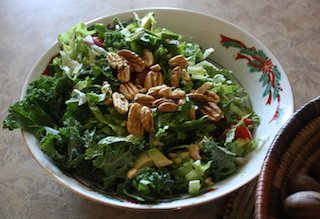 A crispy tossed salad topped with pecans