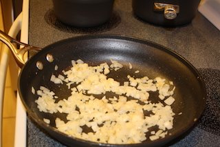 onions and garlic sauteing in the skillet